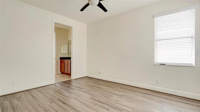 a bathroom with a granite countertop sink mirror toilet and bathtub