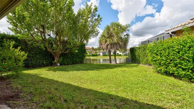 an aerial view of a house with a garden and lake view
