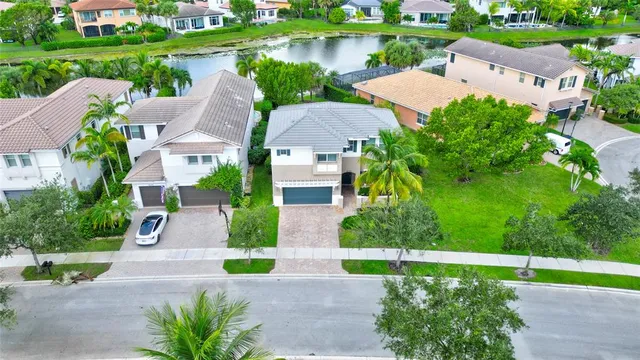 an aerial view of lake and residential houses with outdoor space