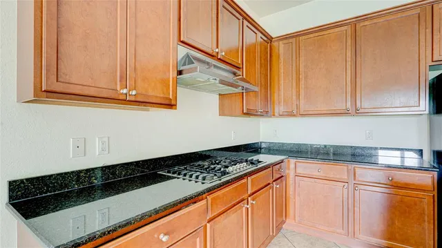 a kitchen with a sink and a stove top oven