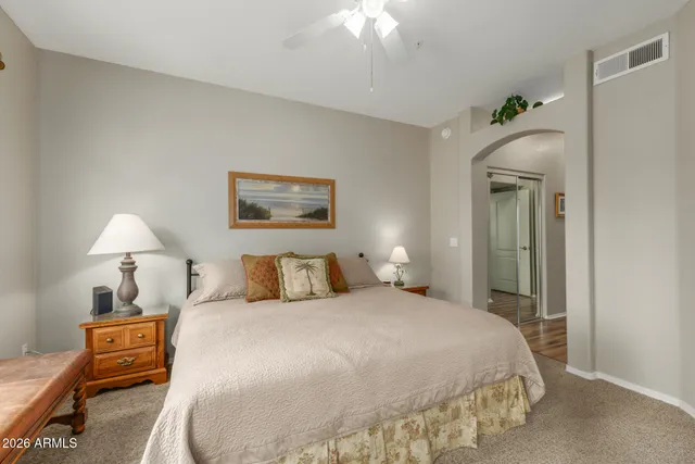 a bedroom with a bed and a chandelier