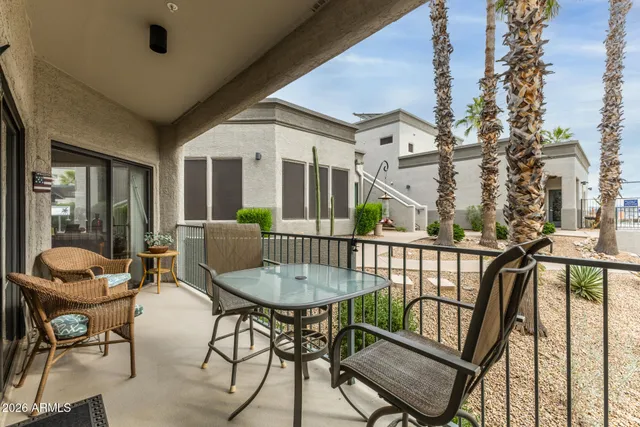 a view of a chairs and table in patio