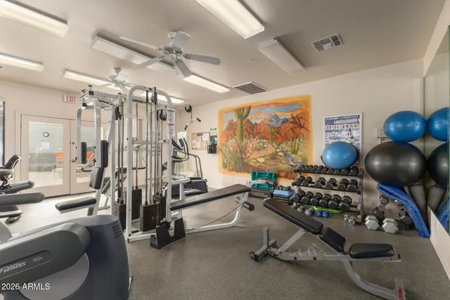 a room with gym equipment and windows