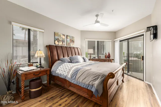 a bedroom with a bed and large window