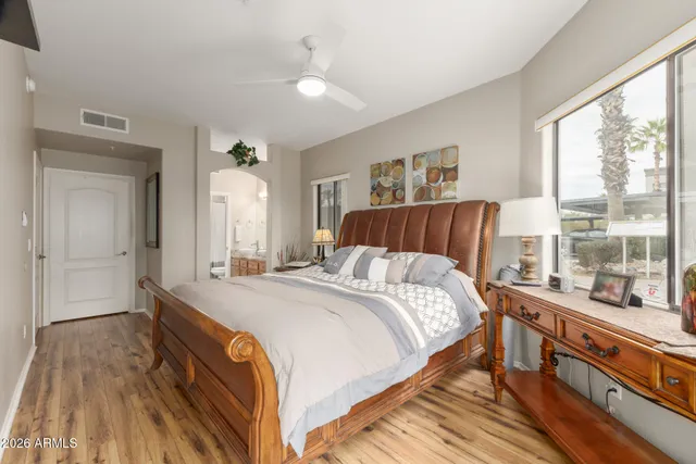 a bedroom with a bed and wooden floor