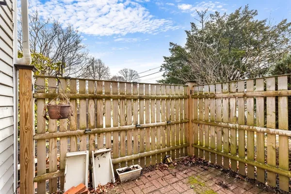 a view of a balcony with wooden fence and floor