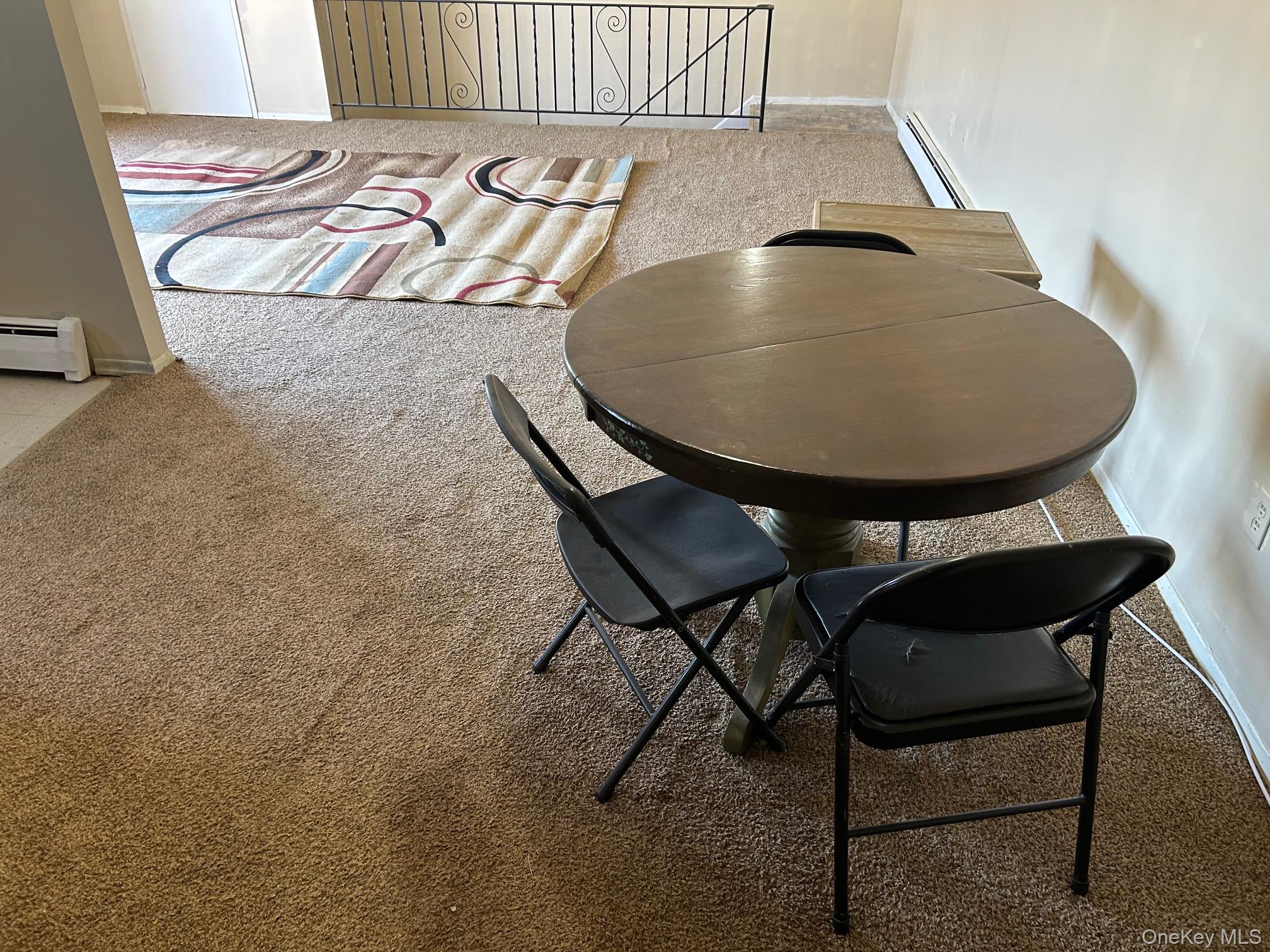 68 Sneden Place West, Unit 68 Spring Valley, NY 10977 - Photo 11 of 24 Dining space with light colored carpet and baseboard heating