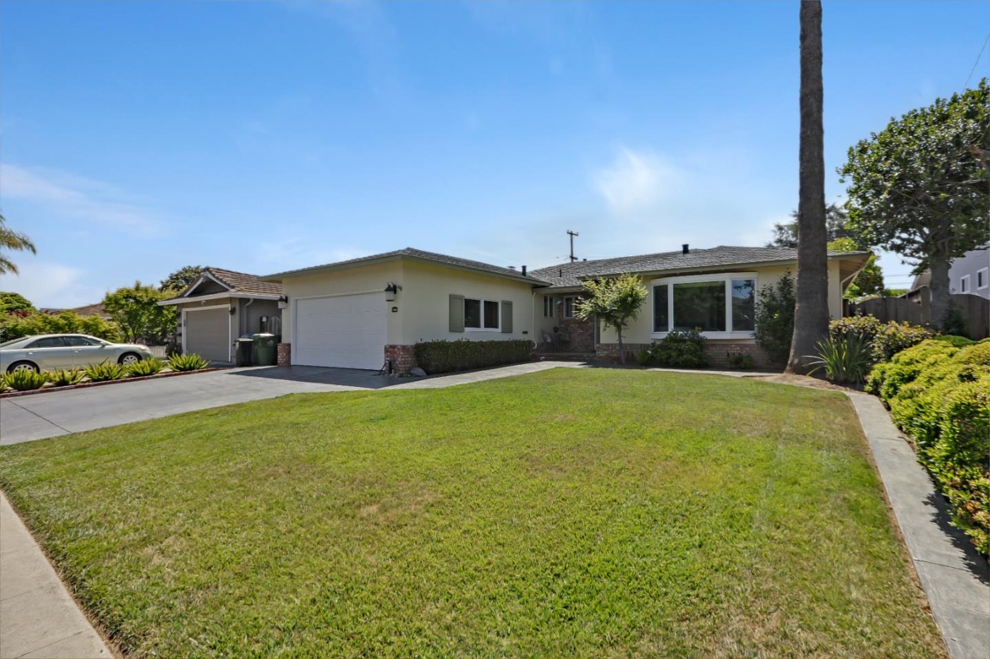 a view of a house with a backyard and a patio