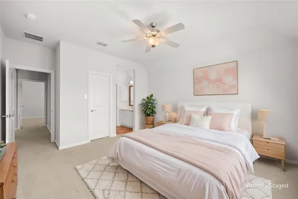 a bedroom with a large bed and a chandelier