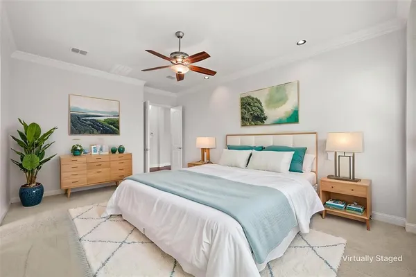 a spacious bedroom that has a bed and a chandelier
