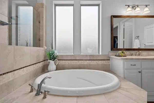 a bathroom with a tub and a sink