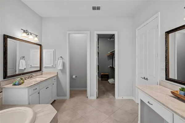 a spacious bathroom with a granite countertop sink mirror and toilet