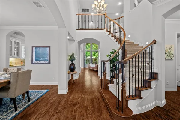 a view of entryway and hall with wooden floor