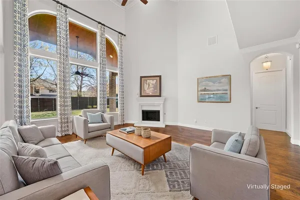 a living room with furniture fireplace and a large window