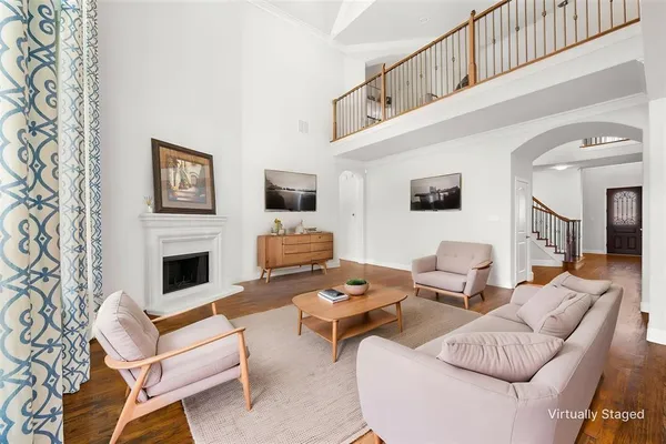 a living room with furniture a fireplace and a flat screen tv