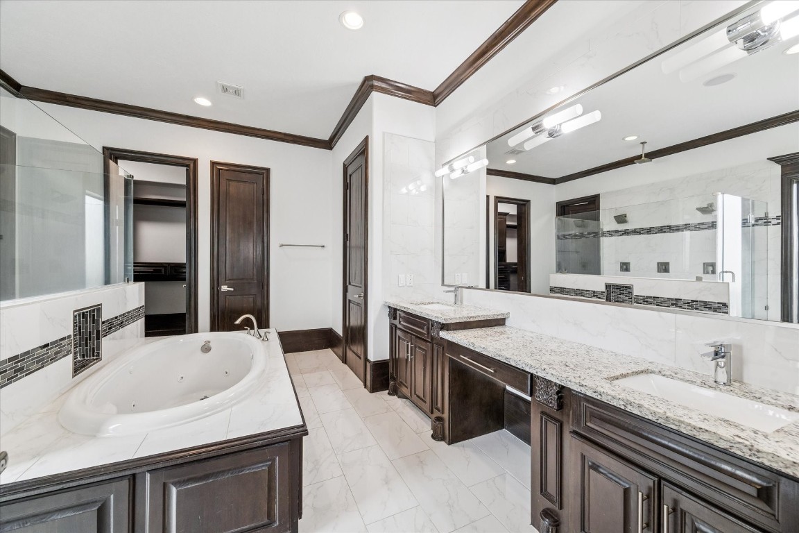 3942 Charleston Street Houston, TX 77021 - Photo 14 of 34 a bathroom with a granite countertop sink a large mirror and a bathtub