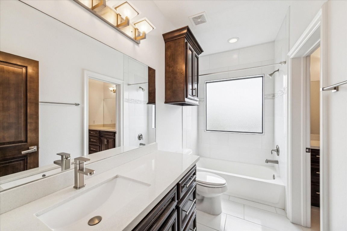 3942 Charleston Street Houston, TX 77021 - Photo 21 of 34 a bathroom with a granite countertop sink a toilet and shower