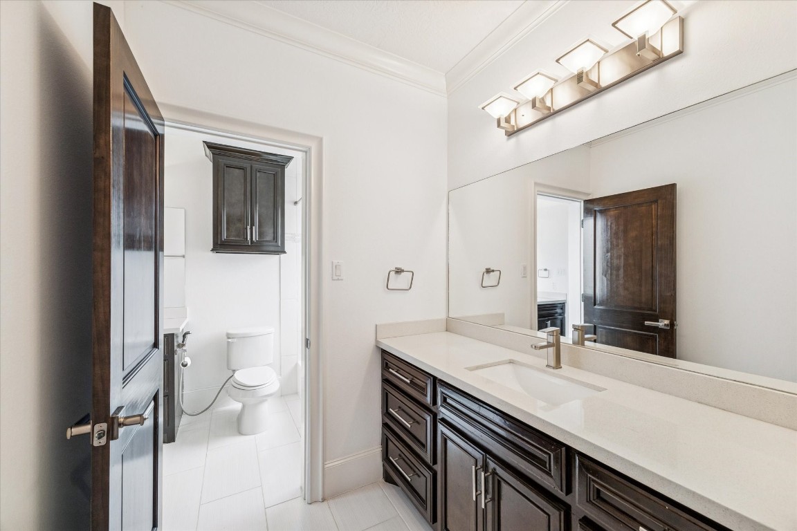 3942 Charleston Street Houston, TX 77021 - Photo 23 of 34 a bathroom with a sink a toilet and a mirror