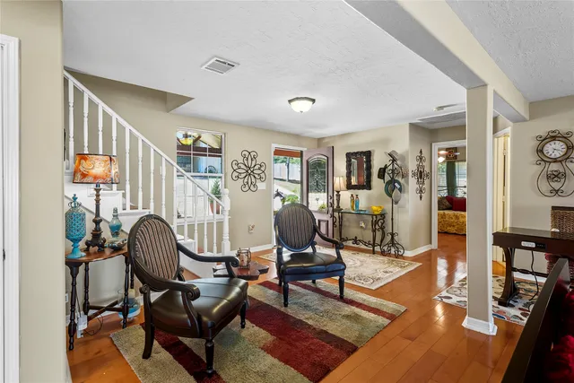 a living room with furniture and a floor to ceiling window