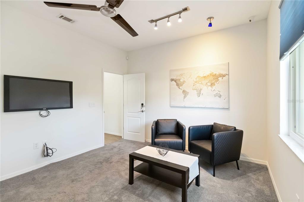 4223 Balmoral Way Sarasota, FL 34238 - Photo 11 of 72 a living room with furniture and a flat screen tv