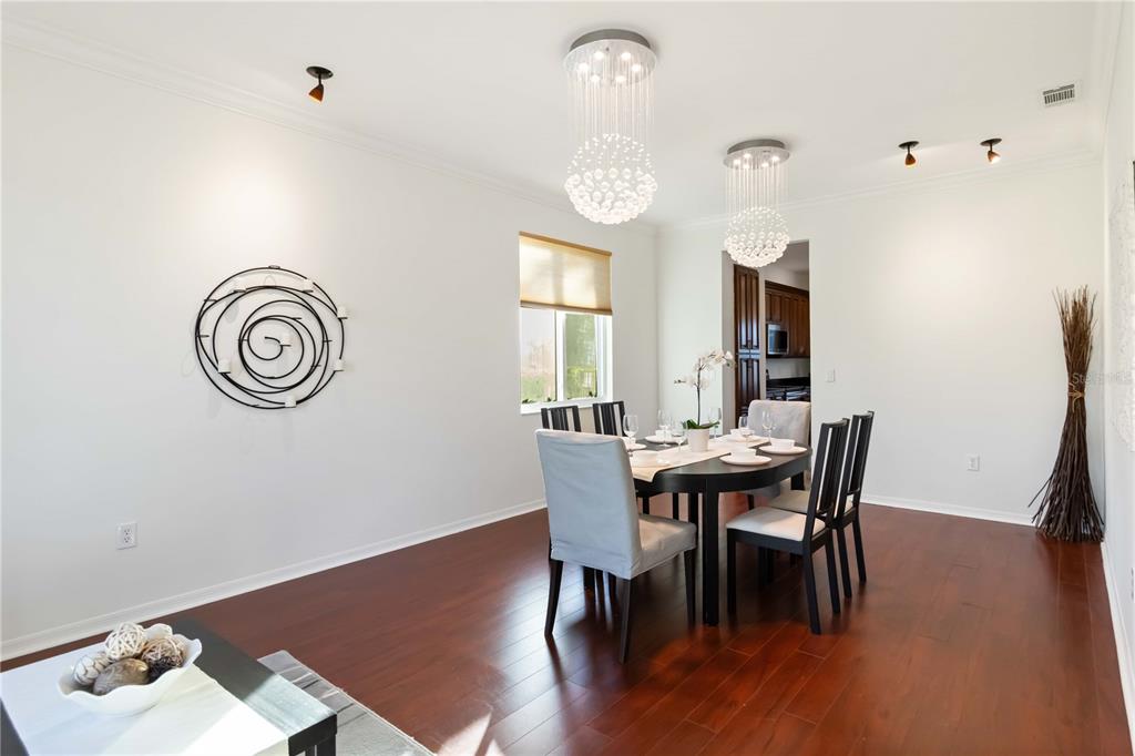 4223 Balmoral Way Sarasota, FL 34238 - Photo 15 of 72 a view of a dining room with furniture and wooden floor