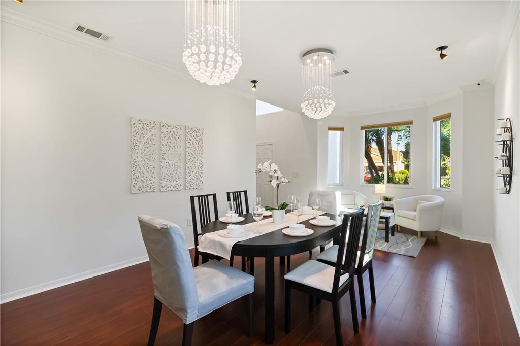 4223 Balmoral Way Sarasota, FL 34238 - Photo 17 of 72 a view of a dining room with furniture and wooden floor