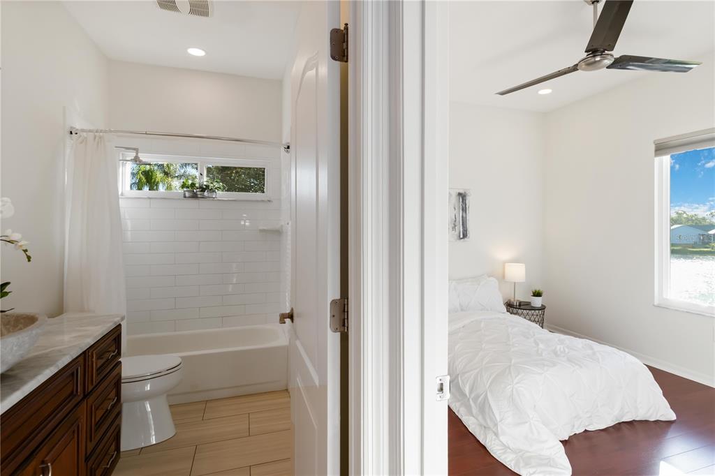 4223 Balmoral Way Sarasota, FL 34238 - Photo 35 of 72 a bathroom with a granite countertop sink a toilet and shower