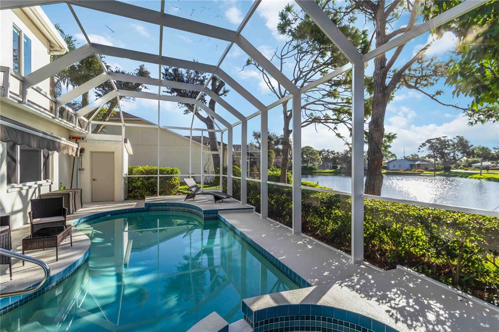 4223 Balmoral Way Sarasota, FL 34238 - Photo 45 of 72 a view of a swimming pool with a patio and a garden