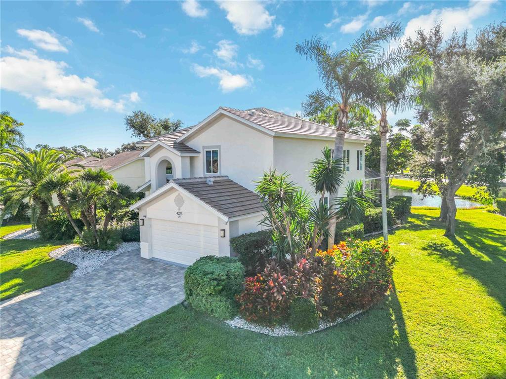 4223 Balmoral Way Sarasota, FL 34238 - Photo 49 of 72 a view of a house with a yard and a garden
