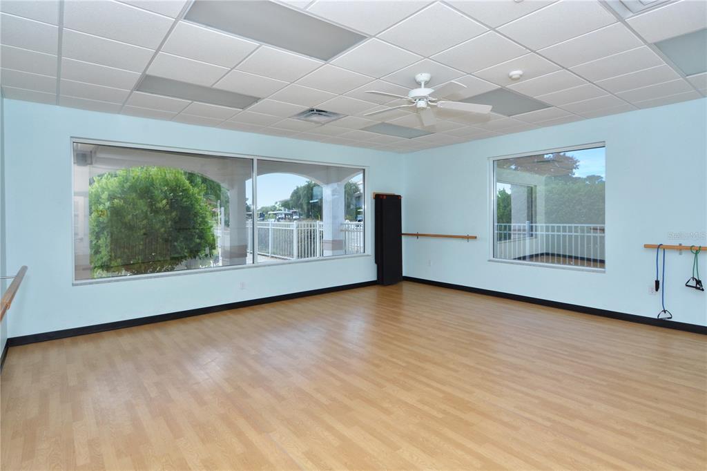 4223 Balmoral Way Sarasota, FL 34238 - Photo 69 of 72 an empty room with wooden floor and windows