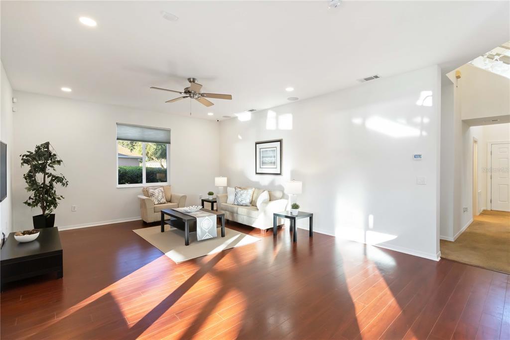 4223 Balmoral Way Sarasota, FL 34238 - Photo 8 of 72 a living room with furniture or wooden floor and a chandelier