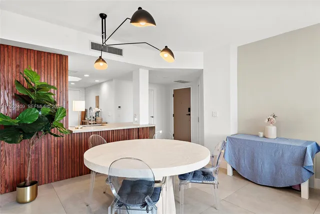 a view of a dining room with furniture and a potted plant