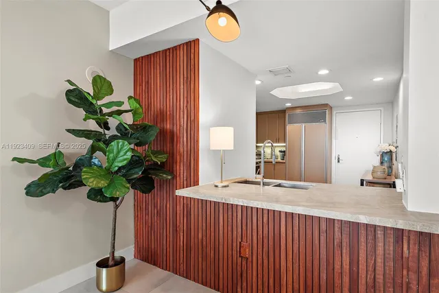 a vase of flowers sitting on a table field with a potted plant
