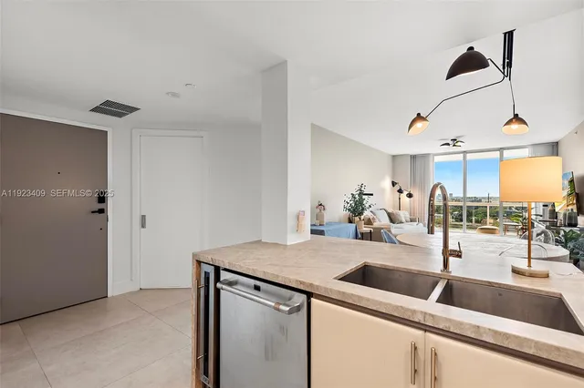 a kitchen with a sink a counter and cabinets