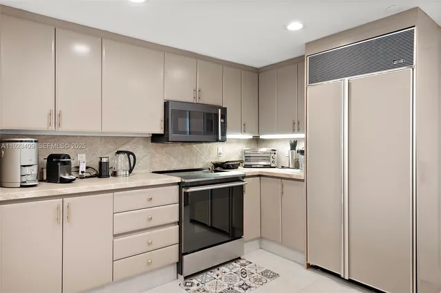 a kitchen with granite countertop white cabinets and white appliances