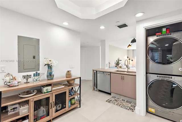 a utility room with cabinets dryer and washer