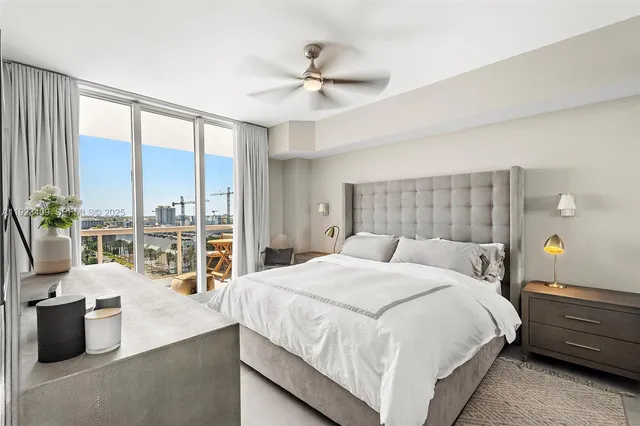 a bedroom with a large bed and a large window