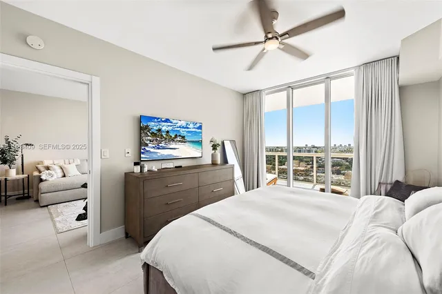 a bedroom with a large bed and a window