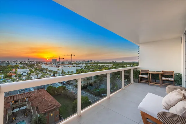 a view of a balcony with couches and wooden floor
