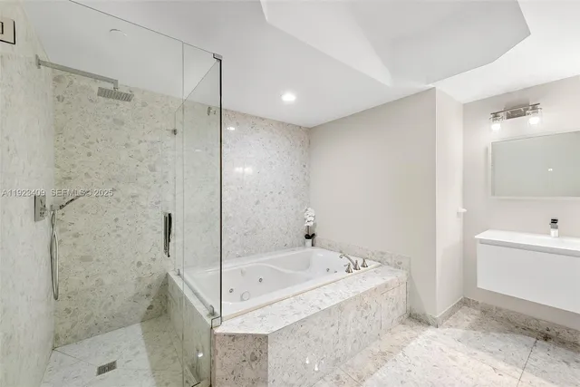 a bathroom with a bathtub and a shower