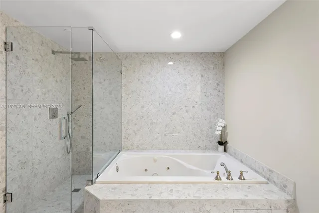 a bathroom with a bathtub and a shower