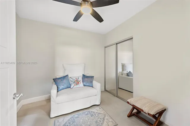 a living room with a bed furniture and a window