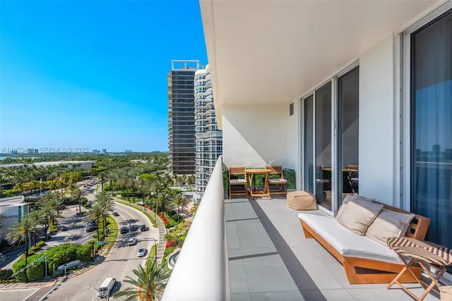 a balcony with furniture and a potted plant