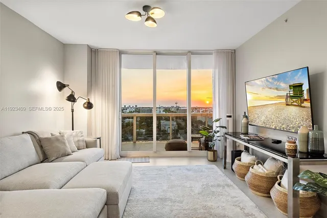 a living room with furniture tv and a large window