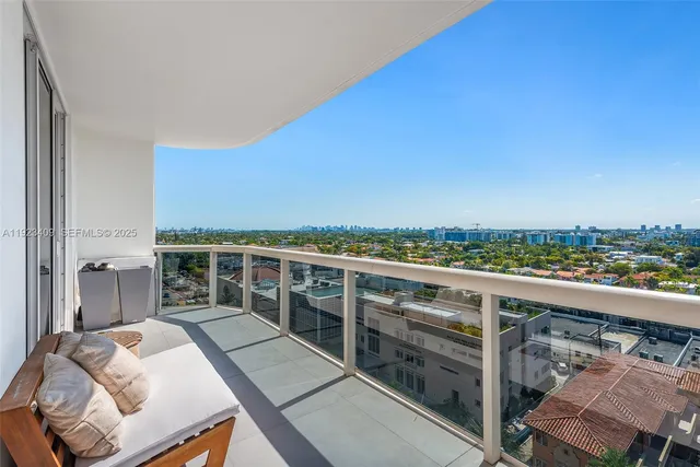 a view of a balcony with two chairs and a table