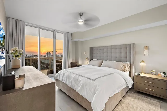 a bedroom with a large bed and a large window