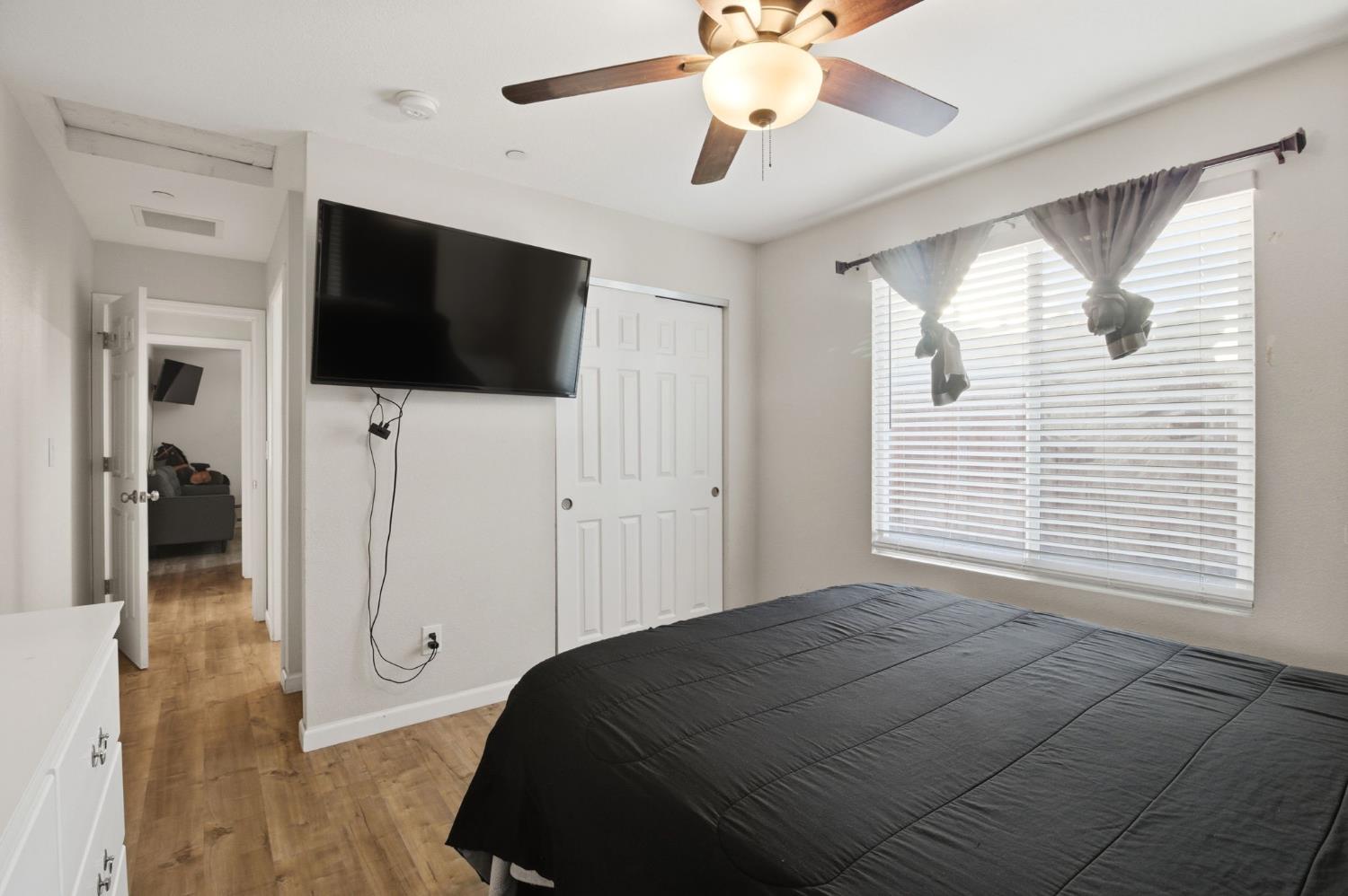 243 Angelus Street Turlock, CA 95380 - Photo 17 of 26 a bedroom with a bed and a flat screen tv