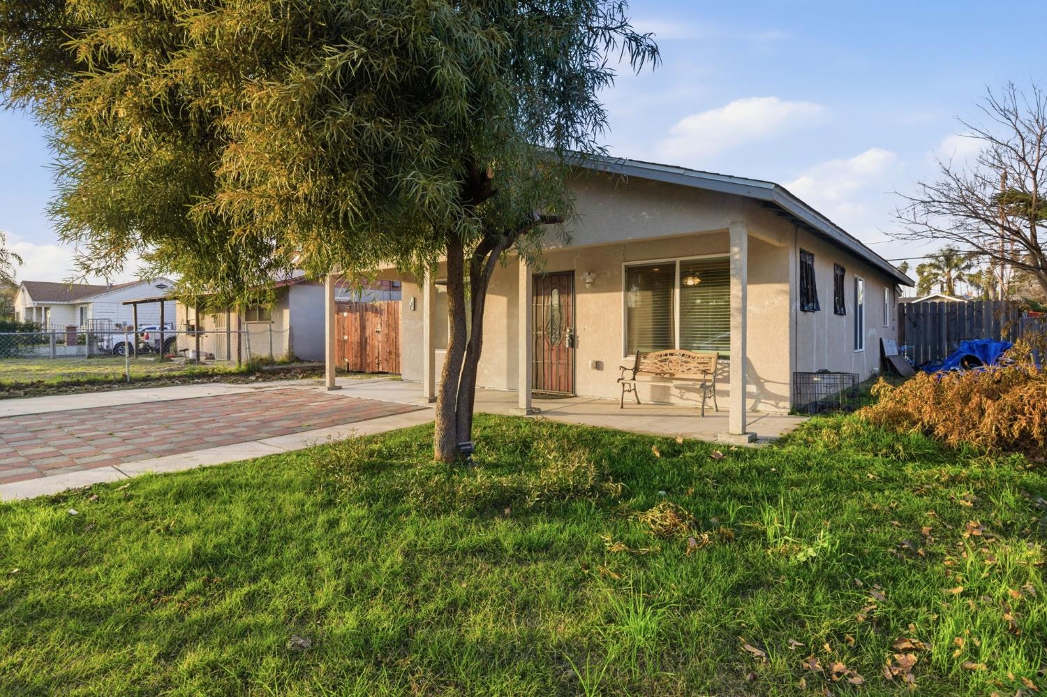 243 Angelus Street Turlock, CA 95380 - Photo 2 of 26 a front view of a house with a yard