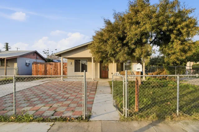 front view of a house with a tree