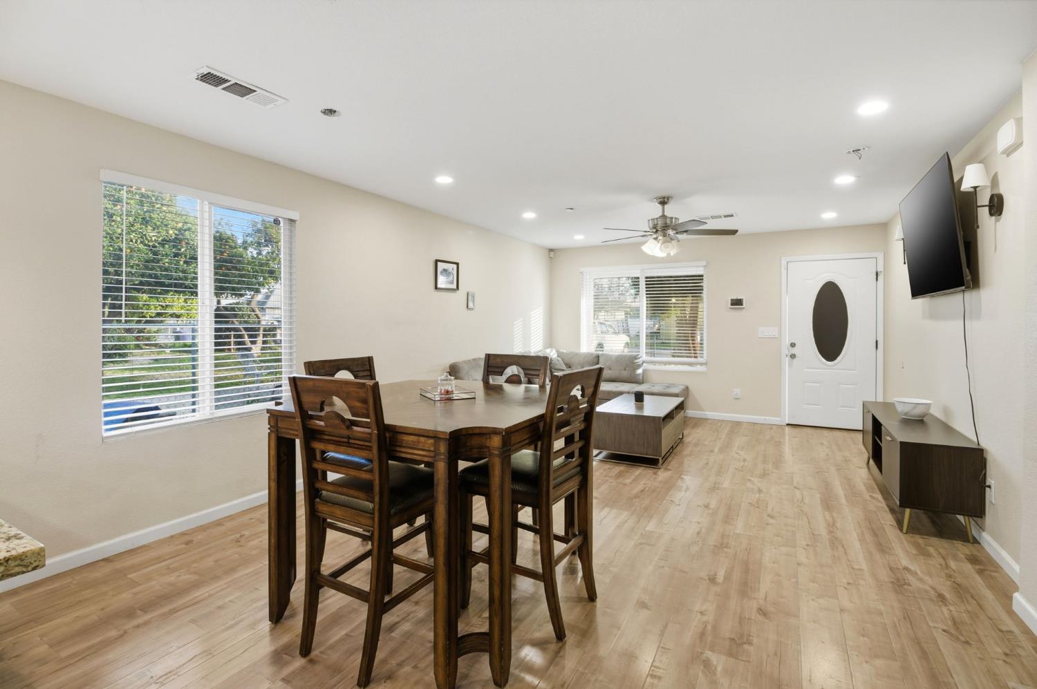243 Angelus Street Turlock, CA 95380 - Photo 7 of 26 a view of a dining room with furniture and wooden floor